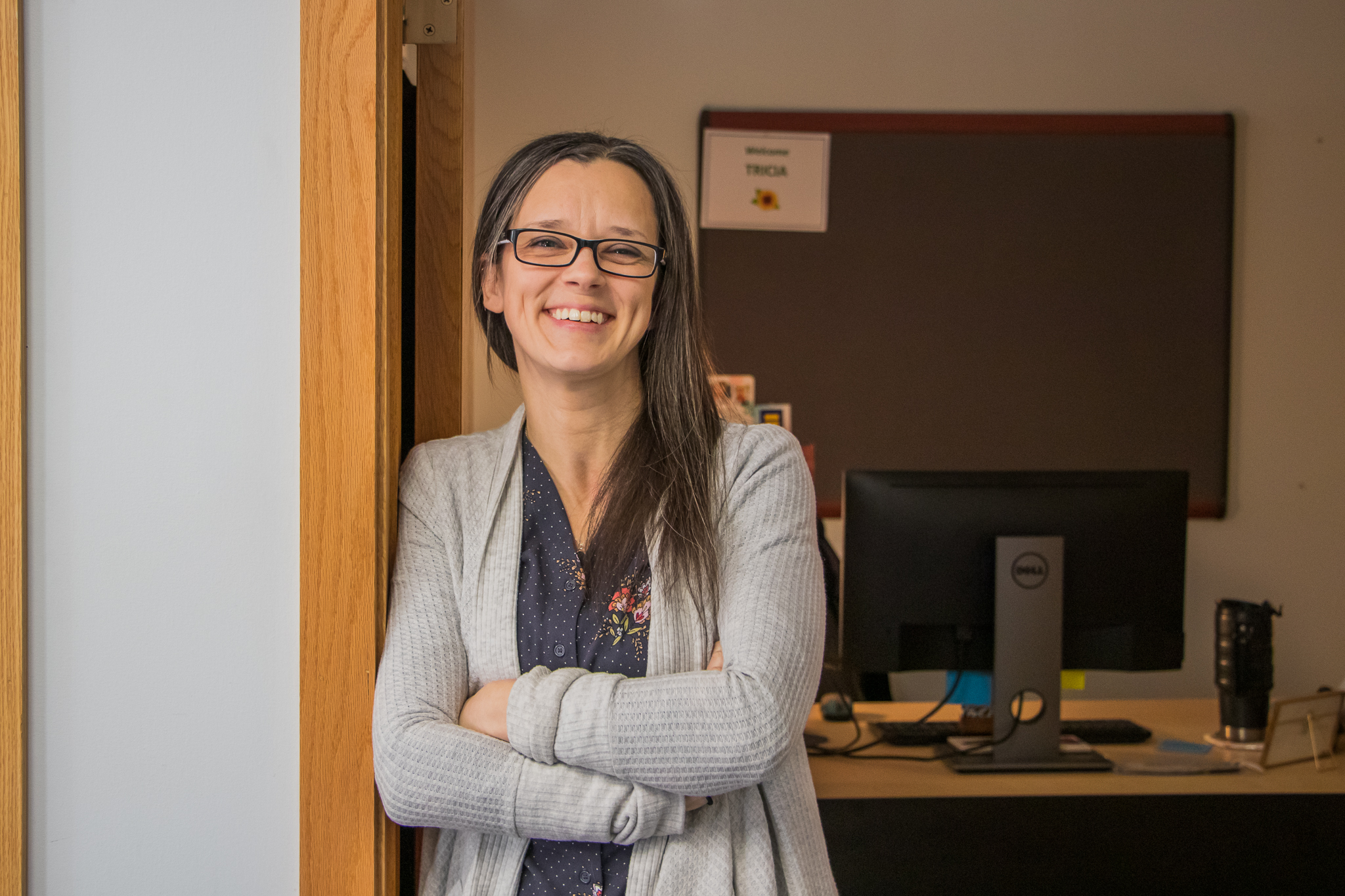 Tricia Headshot Standing in office doorway